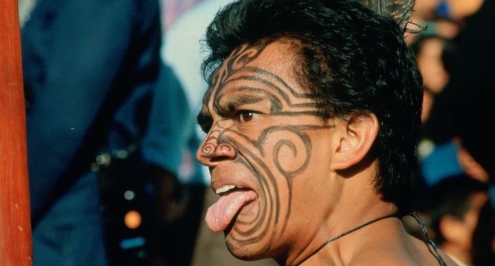 A Maori warrior in New Zealand gives a traditional challenge.