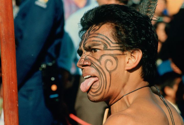 A Maori warrior in New Zealand gives a traditional challenge.