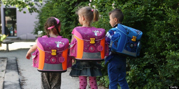 BERLIN, GERMANY - JUNE 05: Kids from kindergarten 'Schneckenhaus' walk along a path with their new satchels on June 5, 2013 in Berlin, Germany. (Photo by Andreas Rentz/Getty Images)