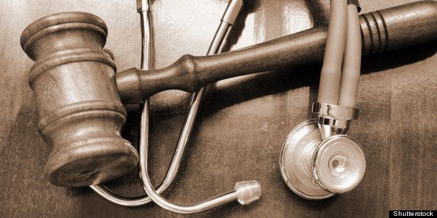 gavel and stethoscope on wooden ...