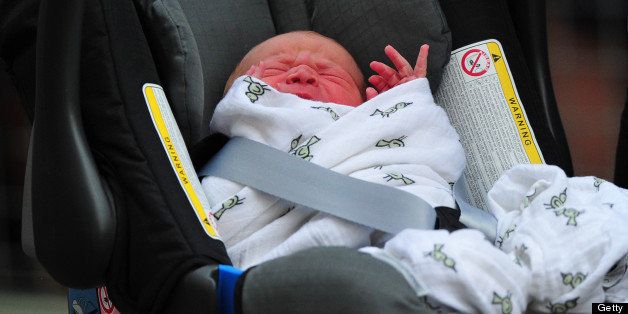 Prince William and Catherine, Duchess of Cambridge' new-born baby boy seen in a car seat outside the Lindo Wing of St Mary's Hospital in London on July 23, 2013. The baby was born on Monday afternoon weighing eight pounds six ounces (3.8 kilogrammes). The baby, titled His Royal Highness, Prince (name) of Cambridge, is directly in line to inherit the throne after Charles, Queen Elizabeth II's eldest son and heir, and his eldest son William. AFP PHOTO / CARL COURT (Photo credit should read CARL COURT/AFP/Getty Images)