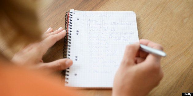 Mid adult woman, writing to do list