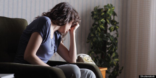 depressed young woman sitting...