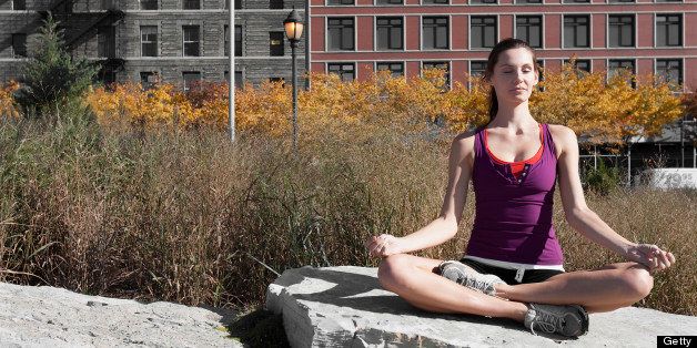 Woman meditating on a rock