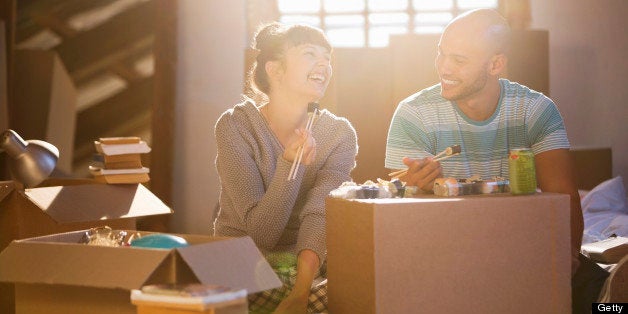 Couple eating sushi together in new home