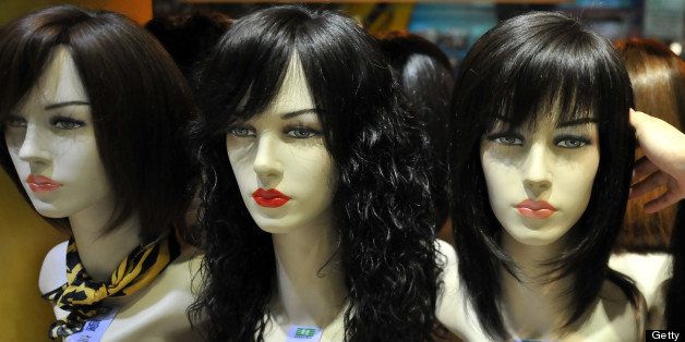 This photograph taken on July 29, 2013 shows a worker arranging wigs at a shop in Taipei. AFP PHOTO / Mandy CHENG (Photo credit should read Mandy Cheng/AFP/Getty Images)