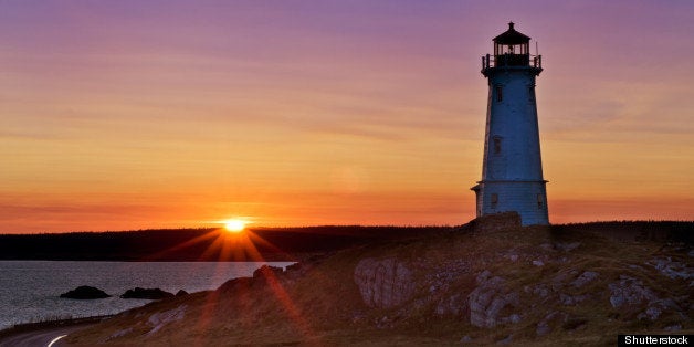 lighthouse during sunrise in...