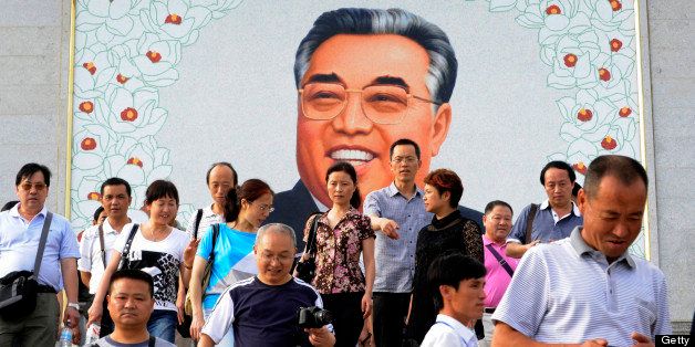 This picture taken on August 29, 2011 shows Chinese tourists leave after paying homage to a giant portrait of Kim Il-sung at a square in Rason city in North Korea on August 29, 2011. Keen to boost tourism and earn much-needed cash, authorities in the impoverished nation have decided to launch a cruise tour from the rundown northeastern port city of Rajin to the scenic resort of Mount Kumgang. AFP PHOTO/GOH CHAI HIN (Photo credit should read GOH CHAI HIN/AFP/Getty Images)