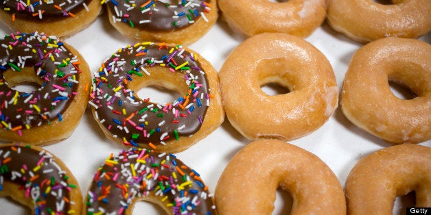 A box of Krispy Kreme Doughnuts Inc. doughnuts is arranged for a photograph in Washington, D.C., U.S., on Monday, June 17, 2013. Krispy Kreme, with about 770 shops globally, has recently promoted fancier drinks, such as frozen pink lemonade and Kaffe Kreme coffees, to help draw customers from competitors including Dunkin' Donuts and Starbucks Corp. Photographer: Andrew Harrer/Bloomberg via Getty Images