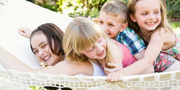 Caucasian children playing in tree