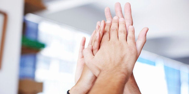 Closeup of hands giving a group high-five