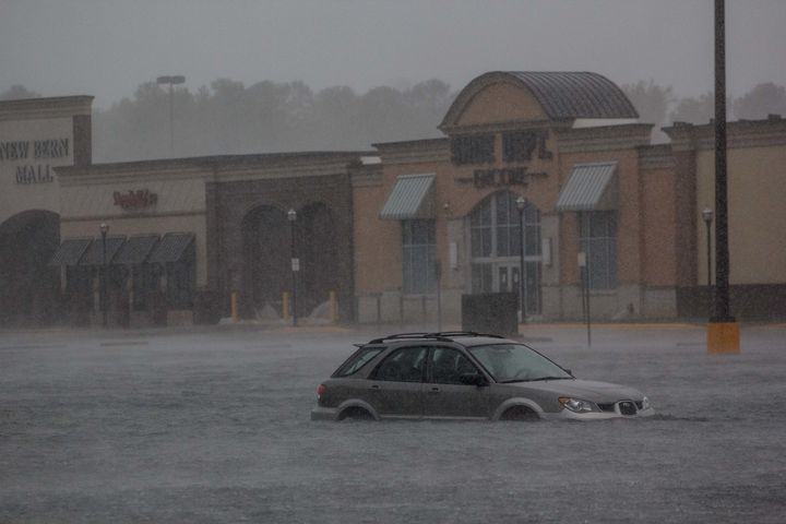 A car is seen in a flooded parking lot outside New Bern Mall in New Bern, N.C.