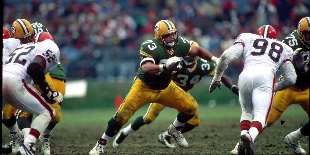 CLEVELAND - NOVEMBER 19: Offensive lineman Aaron Taylor #73 of the Green Bay Packers blocks against the Cleveland Browns at Municipal Stadium on November 19, 1995 in Cleveland, Ohio. (Photo by George Gojkovich/Getty Images)