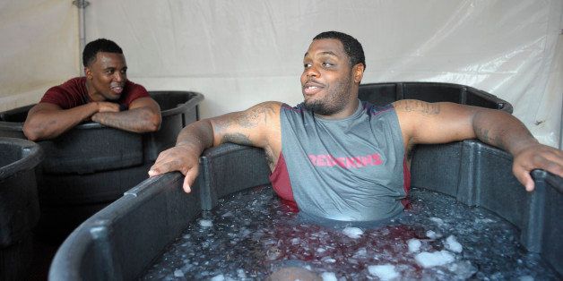 ASHBURN VA JULY 26: Washington Redskins' rookie Wide receiver Darius Hanks , left, talks with Defensive lineman Chris Baker, right, as they sit in tub of ice cooling off after the 1st day of training camp at Redskins Park in Ashburn VA July 26 2012 (Photo by John McDonnell/The Washington Post via Getty Images)
