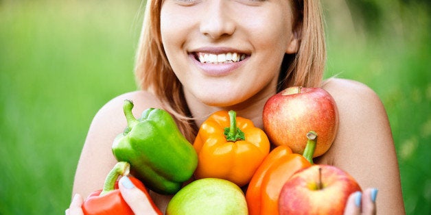 Young lady on diet having positive attitude on losing weight while holding  an apple and weight scale at isolated background Stock Photo - Alamy