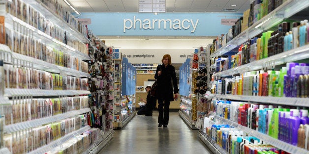 HOLLYWOOD, CA - JANUARY 15: A woman shops in a new Walgreens at the corner of Sunset and Vine on January 15, 2013 in Hollywood, California. The new 23,500-square-foot, drugstore, the company's 8,000th store and first West Coast flagship, includes high-end cosmetic, skinand hair care brands, a frozen yogurt station, a fresh sushi bar, a coffee and espresso bar, a juice and smoothie bar, a wine and spirits shop with a and a virtual bartender kiosk and a cigar humidor. (Photo by Kevork Djansezian/Getty Images)