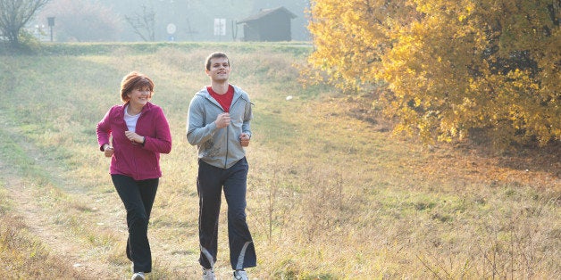 mom and son jogging in a meadow