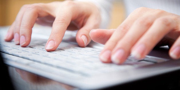 female hands typing on a laptop