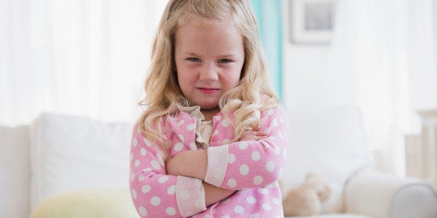 Young girl with arms crossed, unhappy