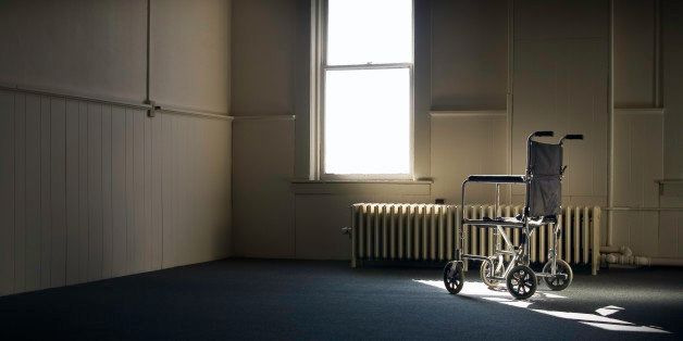 Wheelchair Sitting in Empty Room By Window