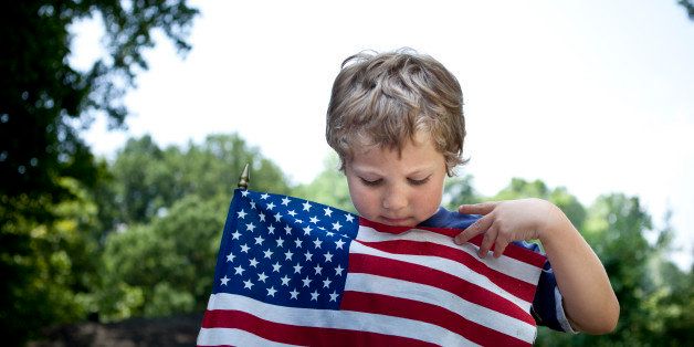 Boy looking at American flag