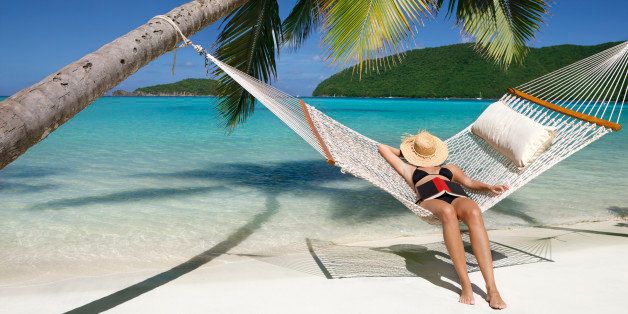 woman napping in hammock at a tropical Caribbean beach