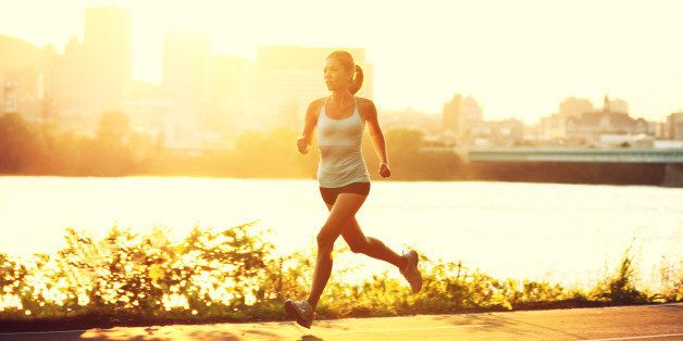 female runner running at sunset ...