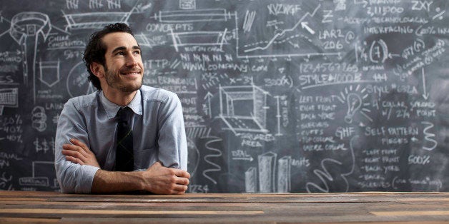 young bussiness man in front of calkboard