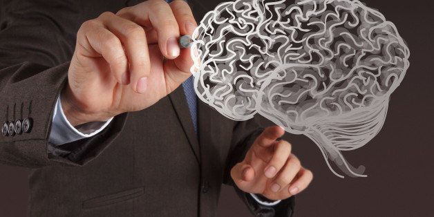 businessman hand drawing a brain