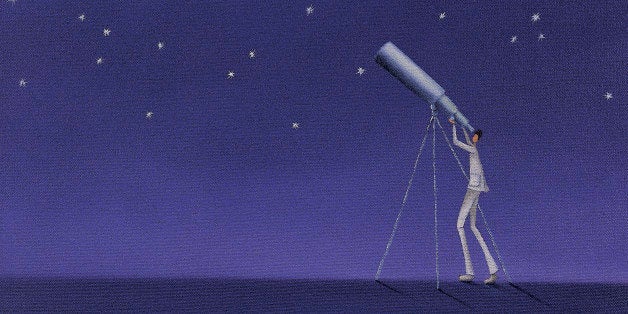 Man Looking Up at Stars With a Telescope