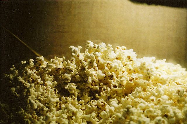 A close-up of a tub of popcorn.