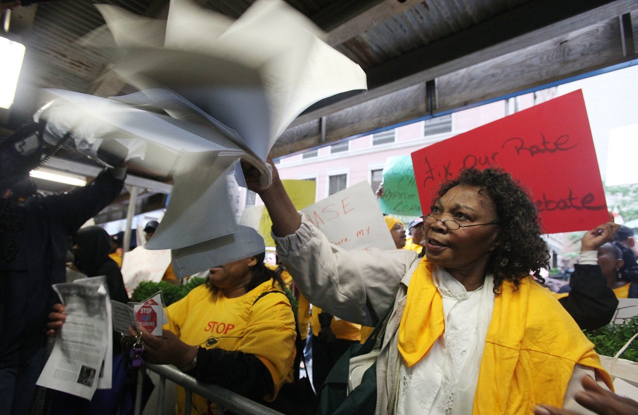 Carmen Edwards waves her mortgage papers during a demonstration outside JPMorgan Chase's annual shareholder meeting in downtown Manhattan on May 18, 2010. Edwards said the bank was attempting to foreclose on her home.