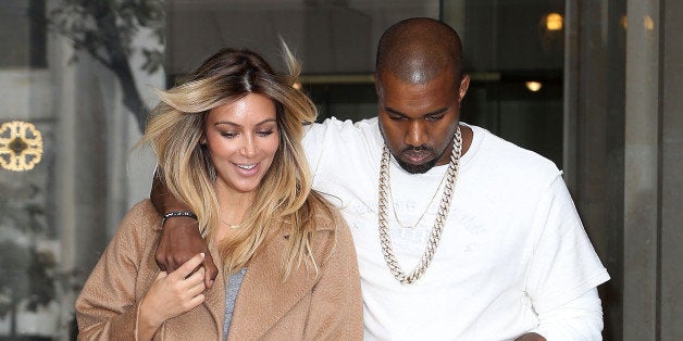 PARIS, FRANCE - SEPTEMBER 28: Kim Kardashian and Kanye West are seen on the 'Avenue Montaigne' on September 28, 2013 in Paris, France. (Photo by Marc Piasecki/WireImage)