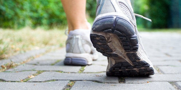 woman walking on sidewalk ...