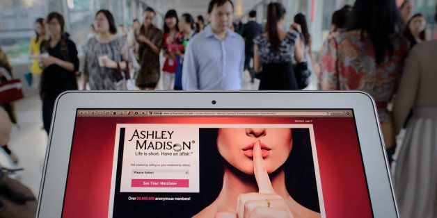 TO GO WITH AFP STORY LIFESTYLE-HONG KONG-INTERNET-SEX, FOCUS by Aaron TamThis photo illustration taken on August 20, 2013 shows the homepage of the Ashley Madison dating website displayed on a laptop in Hong Kong. The founder of a dating service promoting adultery is setting his sights on China's cheating hearts after a controversial launch in Hong Kong. AFP PHOTO / Philippe Lopez (Photo credit should read PHILIPPE LOPEZ/AFP/Getty Images)