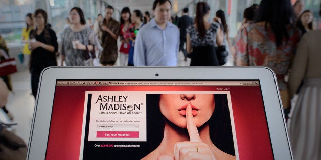 TO GO WITH AFP STORY LIFESTYLE-HONG KONG-INTERNET-SEX, FOCUS by Aaron Tam
This photo illustration taken on August 20, 2013 shows the homepage of the Ashley Madison dating website displayed on a laptop in Hong Kong. The founder of a dating service promoting adultery is setting his sights on China's cheating hearts after a controversial launch in Hong Kong. AFP PHOTO / Philippe Lopez (Photo credit should read PHILIPPE LOPEZ/AFP/Getty Images)