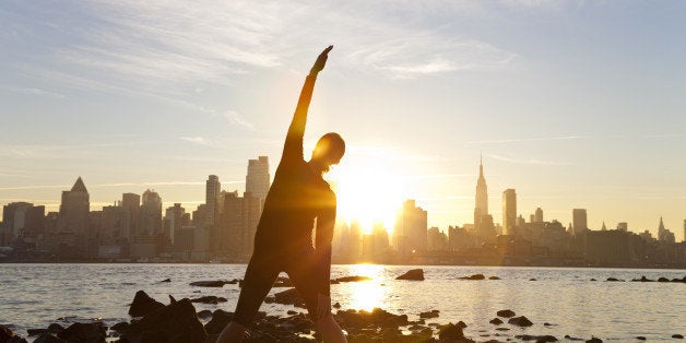 a woman runner stretching in a...