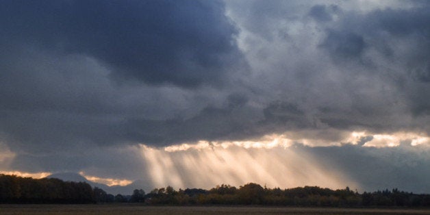 A break in a pounding rainstorm over fields ... while driving through Oregon. Shot from the passenger window at highway speed