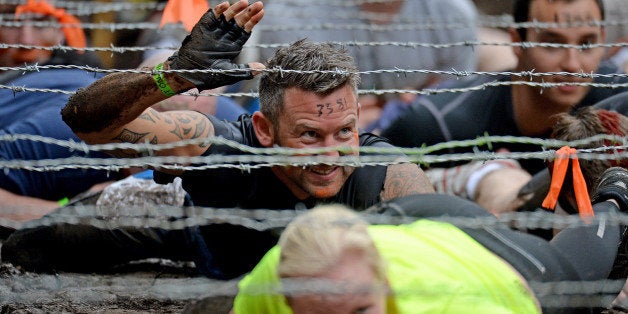 EDINBURGH, SCOTLAND - AUGUST 24: Participents take part in the Tough Mudder endurance event at Dalkieth Country Estate on August 24, 2013 in Edinburgh, Scotland. The world-famous Tough Mudder is military style endurance event over 10-12 miles with various obstacles around the course designed by Briish Special Forces. (Photo by Jeff J Mitchell/Getty Images)