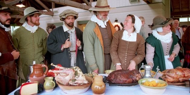 PLYMOUTH, MA - SEPTEMBER 19: Costumed interpreters gather around a table loaded with food for the Harvest Feast of 1621, or 'The First Thanksgiving,' at Plimoth Plantation in Plymouth, Mass. (Photo by Pam Berry/The Boston Globe via Getty Images)