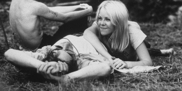 Young couple relaxing during Woodstock Music Festival. (Photo by Bill Eppridge//Time Life Pictures/Getty Images)