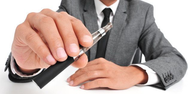 man wearing a suit vaping with...