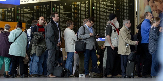 FRANKFURT AM MAIN, GERMANY - MARCH 12: Passengers wait in a long line to rebook their cancelled flights at Frankfurt International Airport on March 12, 2013 in Frankfurt am Main, Germany. Europe's third busiest airport in Frankfurt closed at midday after recording about 12 centimeters of snow. More than 100 flights had already been cancelled and many others were delayed. (Photo by Thomas Lohnes/Getty Images)