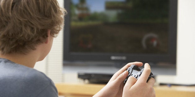 teenage boy playing with game...