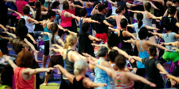 Participants take part in a mass yoga class to mark the summer solstice on Times Square in New York, June 20, 2012. Thousands of yogis gathered on Times Square to celebrate the longest day of the year during the event which features four free mass yoga session at the heart of Manhattan. AFP PHOTO/Emmanuel Dunand (Photo credit should read EMMANUEL DUNAND/AFP/GettyImages)