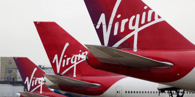 Logos sit on the tailfins of Virgin Atlantic aircraft at Gatwick airport in Crawley, U.K., on Thursday, Jan. 10, 2013. Gatwick, acquired by Global Infrastructure Partners Ltd. in 2009 after regulators sought a breakup of BAA Ltd., owner of the larger Heathrow hub, is 30 miles (48 kilometers) south of London and serves about 200 destinations, more than any other U.K. airport, according to flight schedule data provider OAG. Photographer: Chris Ratcliffe/Bloomberg via Getty Images