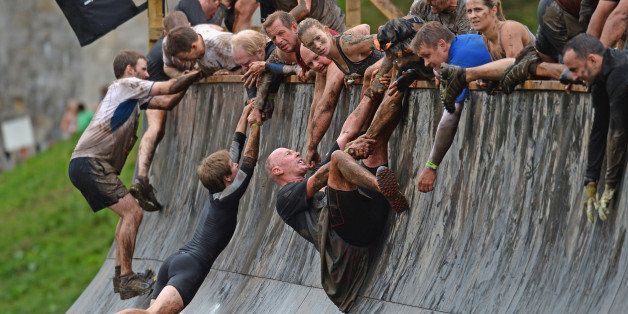 EDINBURGH, SCOTLAND - AUGUST 24: Participents take part in the Tough Mudder endurance event at Dalkieth Country Estate on August 24, 2013 in Edinburgh, Scotland. The world-famous Tough Mudder is military style endurance event over 10-12 miles with various obstacles around the course designed by Briish Special Forces. (Photo by Jeff J Mitchell/Getty Images)