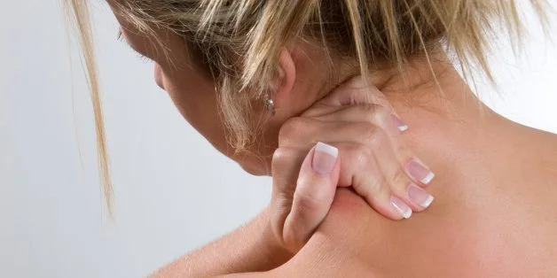 young adult woman rubs her...
