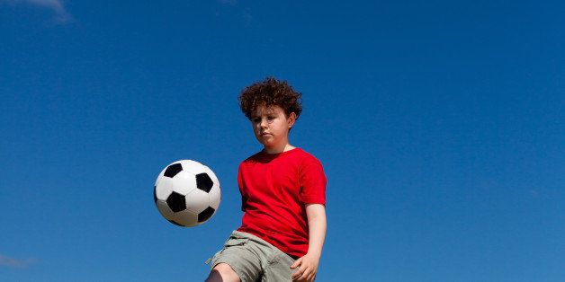 boy playing football outdoor