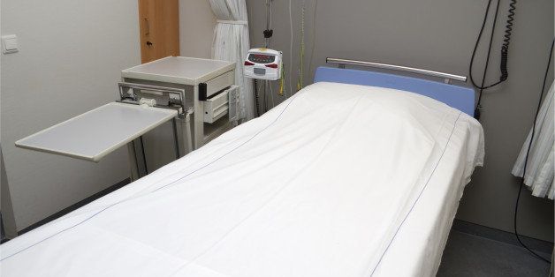 empty bed in hospital room.